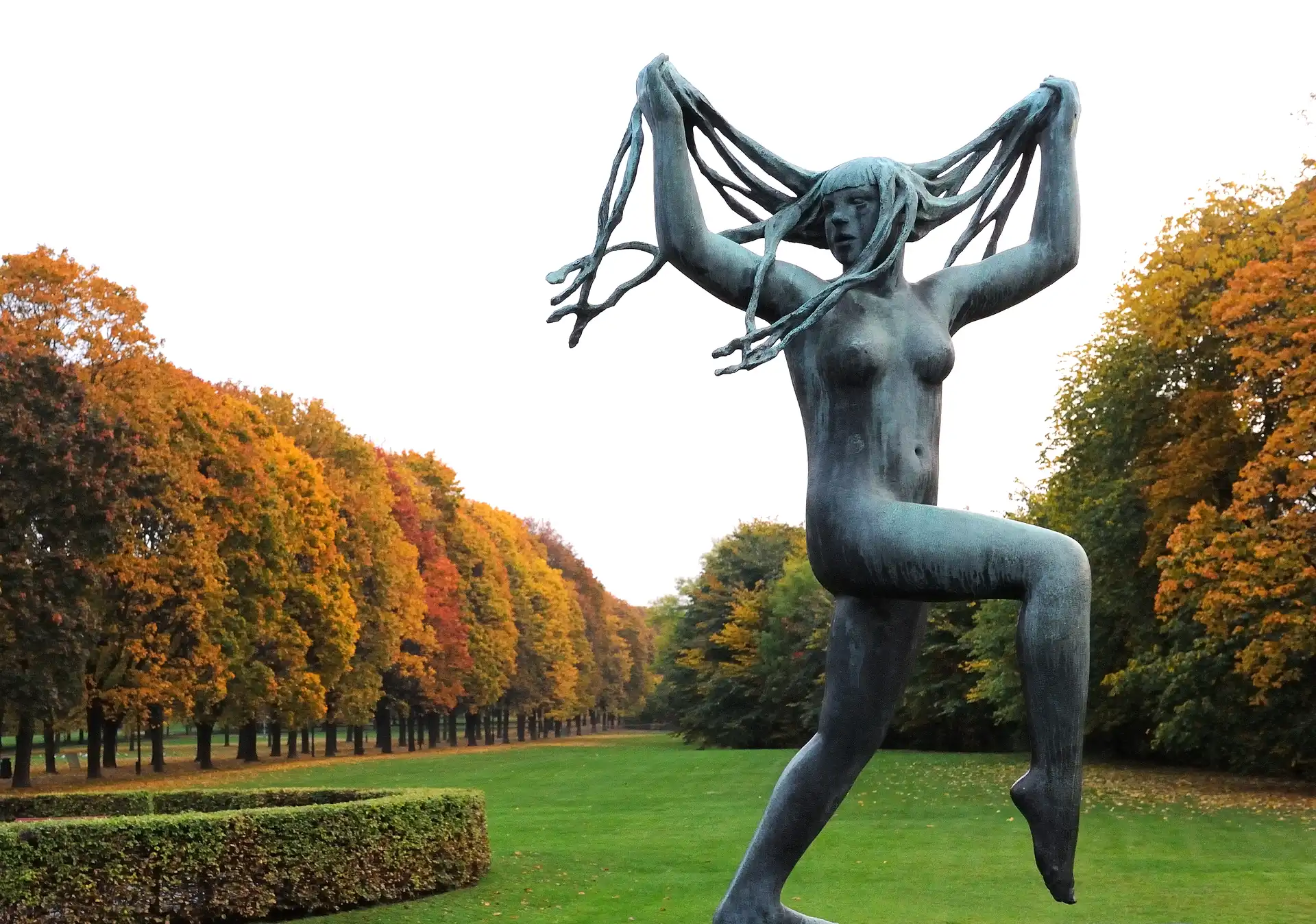 Dancing In Autumn, Vigeland sculpture and autumn foliage in Frogner Park in Oslo Norway